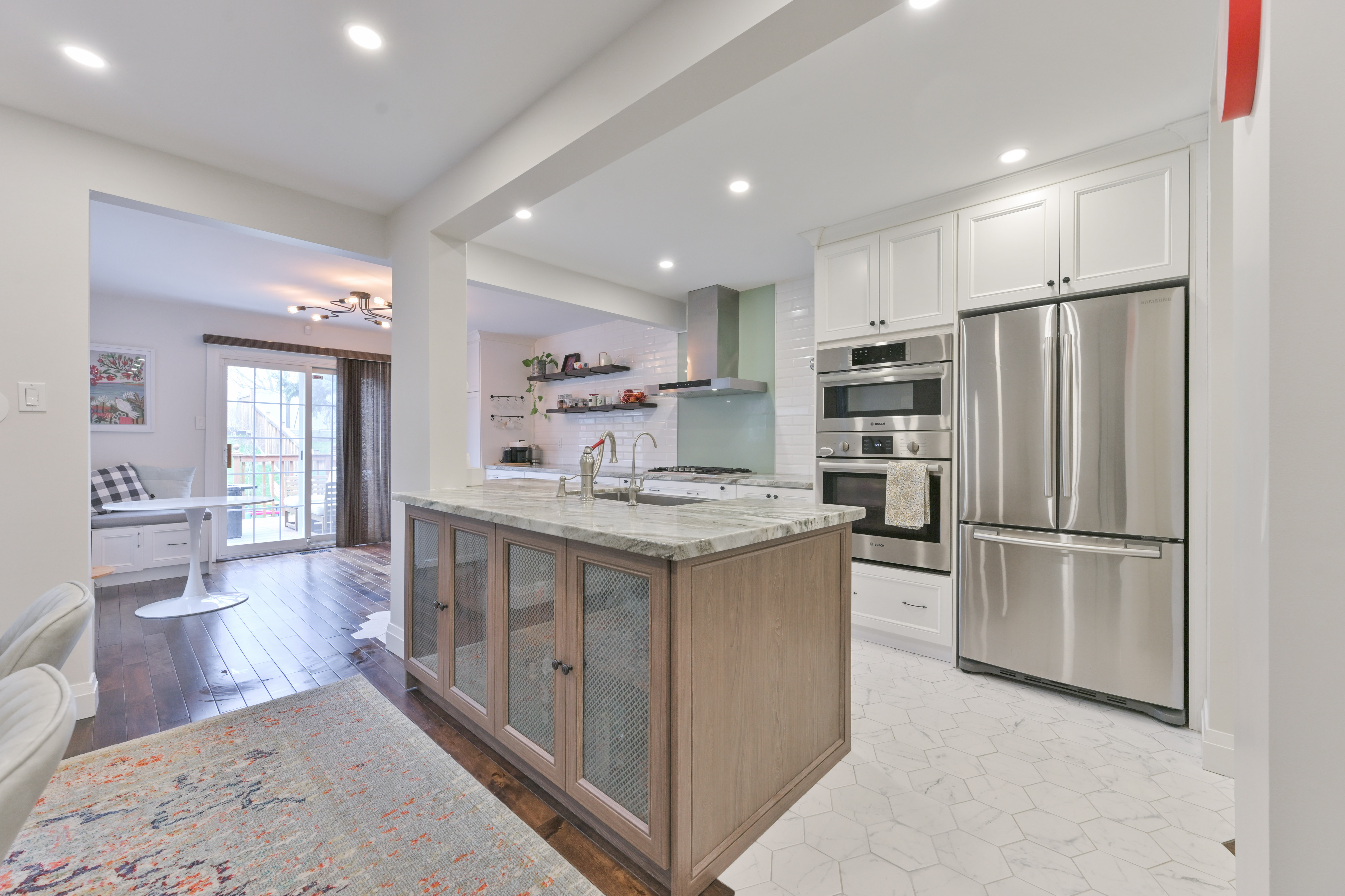 Open-concept kitchen with marble island and dining