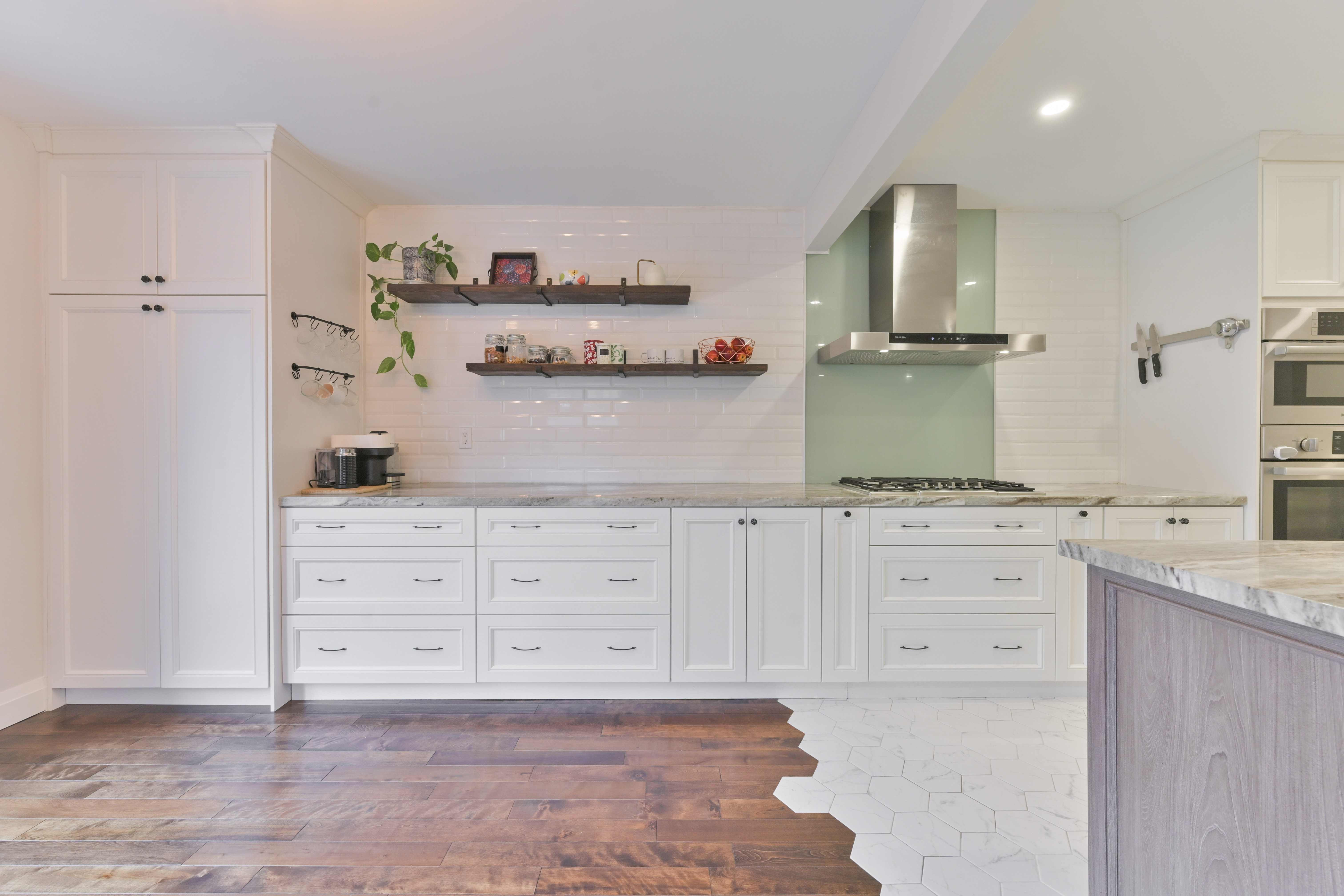 Cooktop and stainless hood with painted glass backsplash