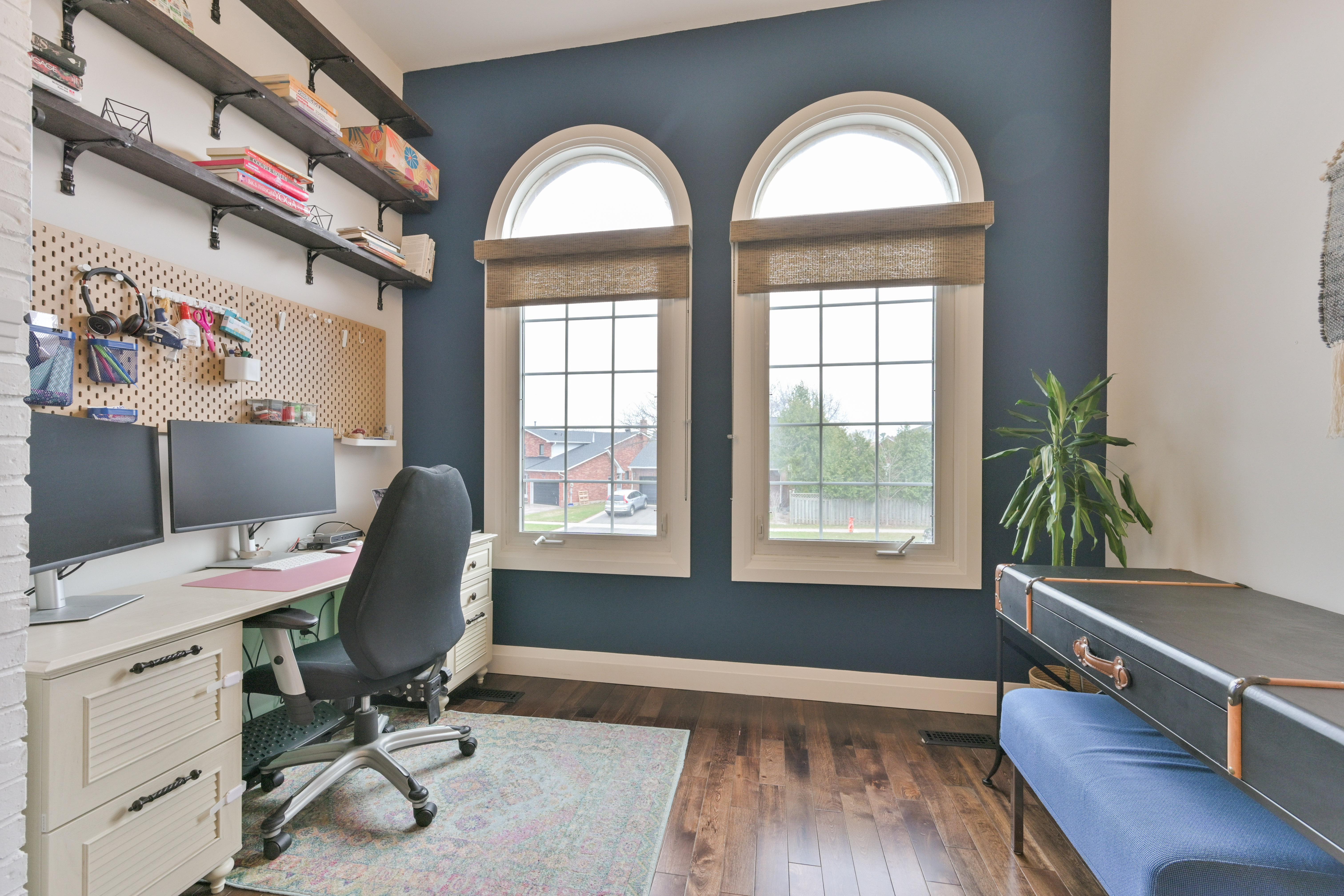 Family room with designer chandeliers and arched windows